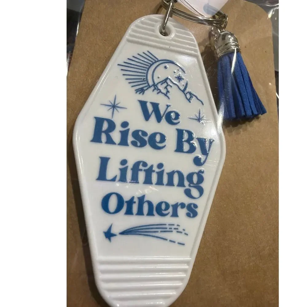We Rise By Lifting Others White & Blue Tassel Vintage Hotel Motel Keychain